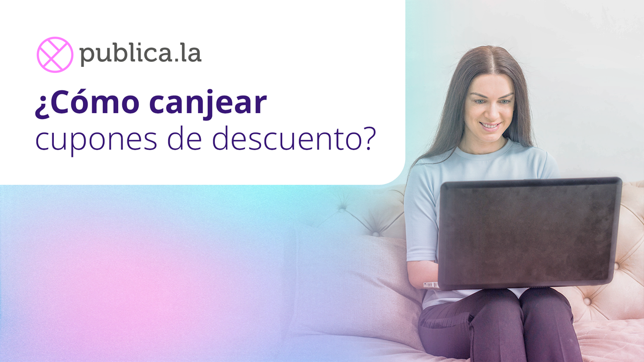 Mujer sentada en un sillón, sonriendo, mirando una computadora